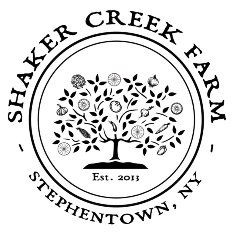 A black and white circular logo for Shaker Creek Farm featuring a stylized tree with various fruits and vegetables.