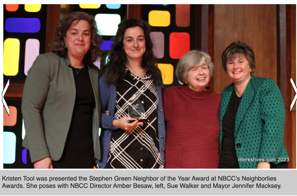 Kristen Tool receives the Stephen Green Neighbor of the Year Award at NBCC’s Neighborlies Awards, posing with three other women in front of a colorful backdrop.